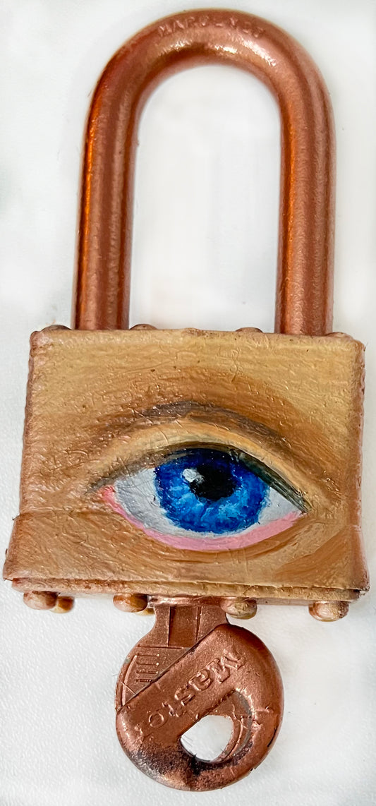 A padlock with a key, featuring an eye painted on it using oil paint and spray paint.