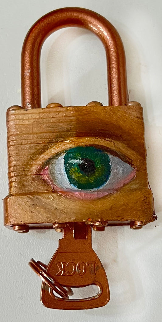 A padlock with a key, featuring an eye painted on it using oil paint and spray paint.