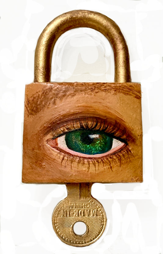 A padlock with a key, featuring an eye painted on it using oil paint and spray paint.