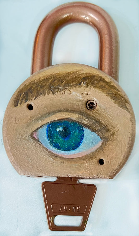 A padlock with a key, featuring an eye painted on it using oil paint and spray paint.
