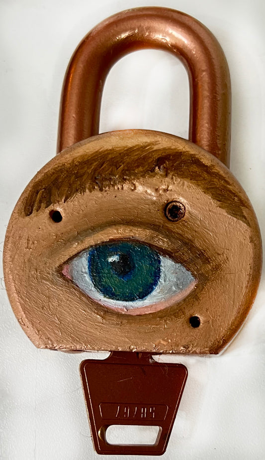 A padlock with a key, featuring an eye painted on it using oil paint and spray paint.